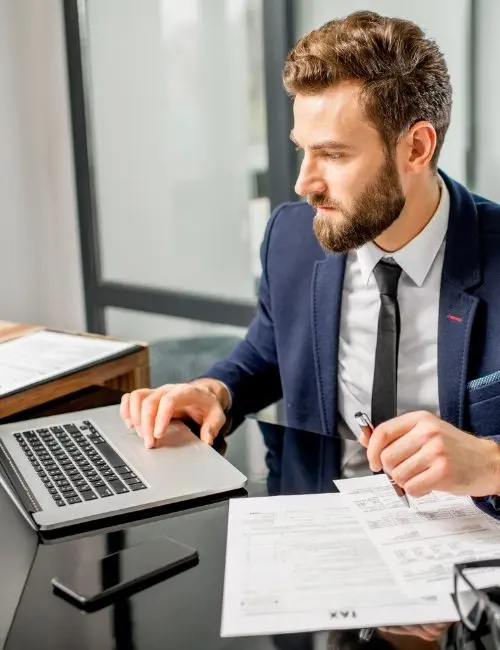 IRHA corporate tax consultant reviewing financial documents and reports for tax filing in Dubai, UAE.